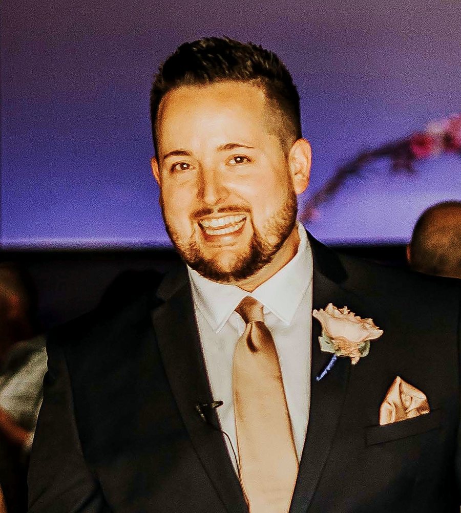 Jerry Ellis, founder of Ellis Creative, smiling in a dark suit